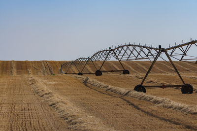 Traditional windmill on field against clear sky