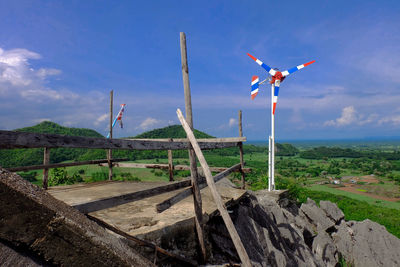 Traditional windmill on field against sky