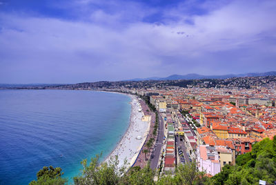 High angle view of townscape by sea against sky