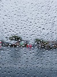 Full frame shot of wet glass window during rainy season