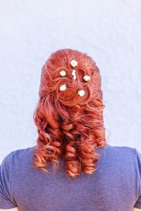 Rear view of woman with flowers in hair