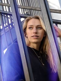 Portrait of beautiful young woman in car