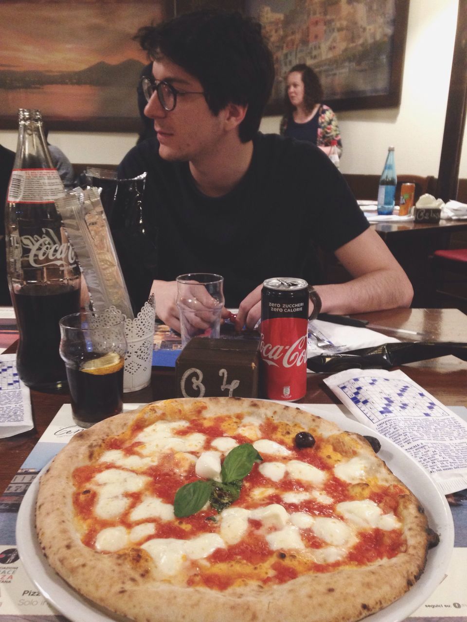 two people, table, pizza, men, lifestyles, young men, indoors, food and drink, young adult, fast food, waist up, women, unhealthy eating, friendship, eating, drink, food, adult, real people, adults only, people, eyeglasses, togetherness, young women, only men