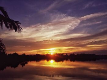 Scenic view of silhouette trees against sky at sunset