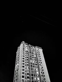 Low angle view of modern building against sky at night