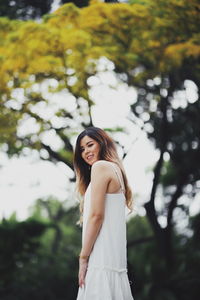 Portrait of a smiling young woman standing outdoors