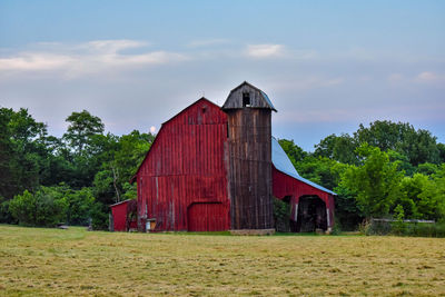 High angle view of barn on grassy field against sky