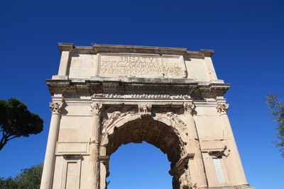 Low angle view of historical building against blue sky