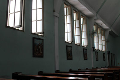 Low angle view of empty benches in building