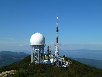 Traditional windmill against clear blue sky