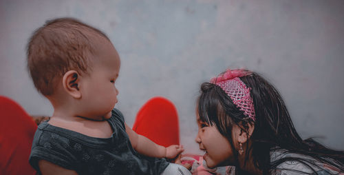 Smiling girl looking at sibling