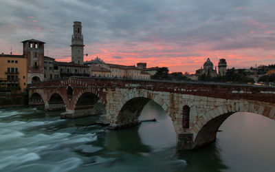 View of ponte pietra bridge at sunset