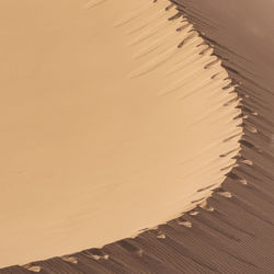 High angle view of sand at beach during sunset