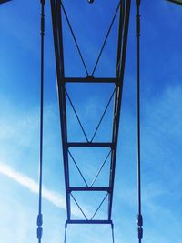 Low angle view of cables against blue sky