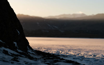 Scenic view of snowcapped mountains against sky during sunset