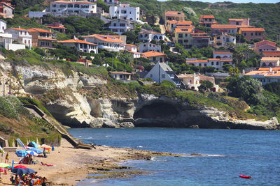 Buildings by sea in city