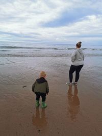 Mother and son looking into sea