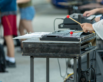 A sideline percussionist performing at an outdoors rehearsal