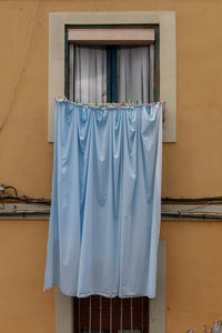 Clothes drying against white wall of building