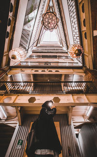 Low angle view of woman walking on ceiling in temple