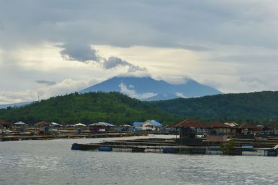 Scenic view of sea and mountains against sky