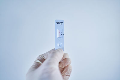 Low angle view of person hand against white background