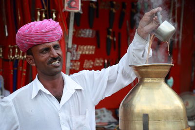 Man preparing tea at market stall