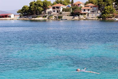 High angle view of woman swimming in sea