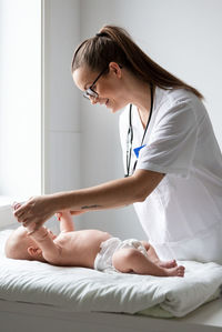 Female doctor examining baby