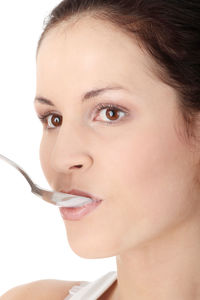 Close-up portrait of young woman over white background