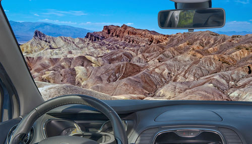 Car in mountains seen through windshield