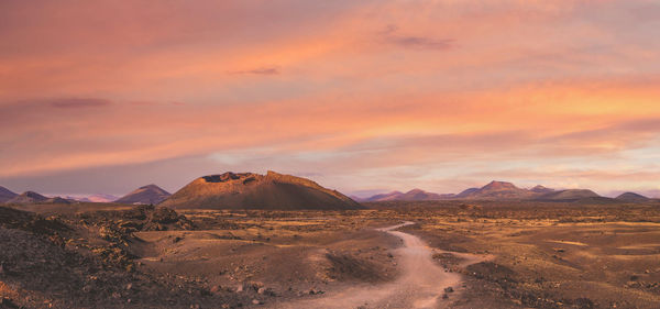 Scenic view of desert against sky during sunset