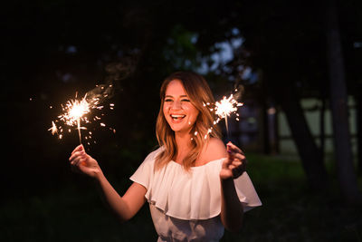 Young woman smiling in park