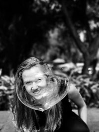 Portrait of woman seen through bubble