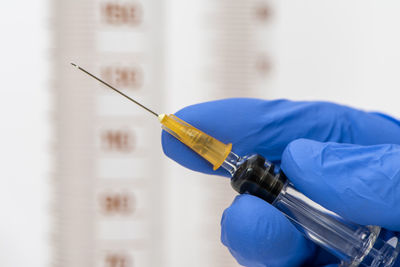 Close-up of healthcare worker holding syringe