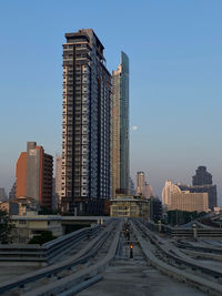 Buildings in city against clear sky