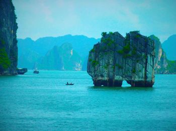 Stack rock in blue sea at halong bay against sky