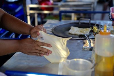 Midsection of man preparing food in kitchen