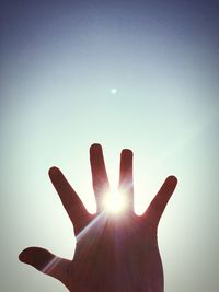 Silhouette of person hand in sunlight