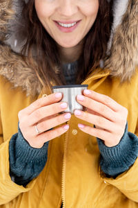 Close-up of a smiling young woman holding ice cream