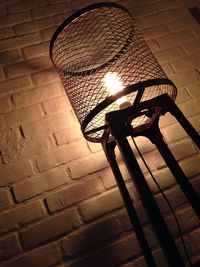 Low angle view of illuminated lighting equipment at night