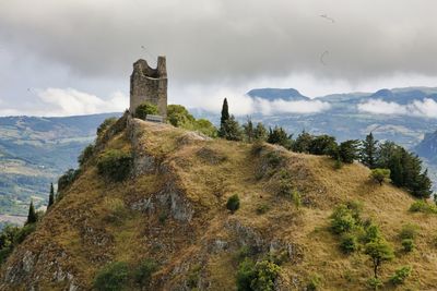 Castle on mountain against sky