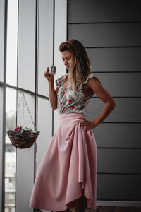 Young woman standing on glass window