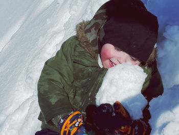 Low section of woman standing on snow covered landscape