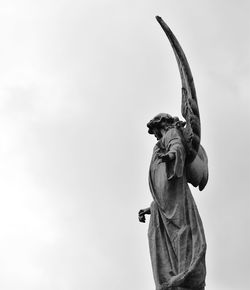 Low angle view of statue against sky