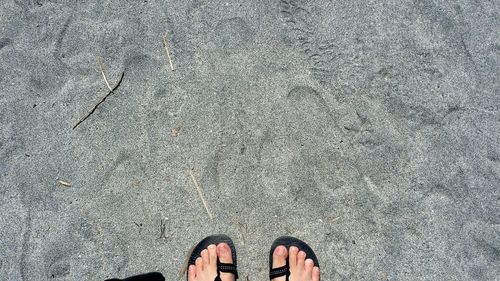 Low section of person standing on tiled floor