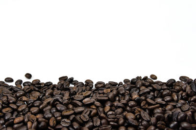 Close-up of coffee beans against white background