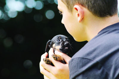 Portrait of man holding dog