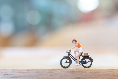 Side view of man riding bicycle on road