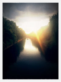 Scenic view of river against sky at sunset